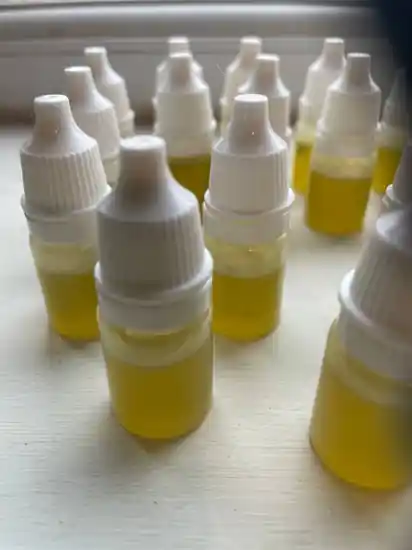 A medical doctor holding a prescription bottle showing where to buy thc oil in uk legally.