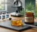 Bask-N Dab Bins premium amber concentrate block on a slate slab next to a product jar and a laboratory microscope for quality testing.