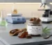 A clear glass jar of Charas Cannabis Infused Gummies labeled with imperialpeptide.com on a laboratory table next to a microscope and beaker.