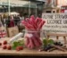 Red traditional red licorice twists in a glass jar alongside fresh wild strawberries and licorice root for an Alpine Strawberry Licorice uk guide.